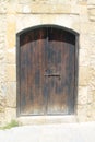 Old wooden door in stone wall Royalty Free Stock Photo