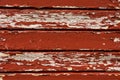 Weathered old horizontal wooden plank wall with peeling red paint texture Royalty Free Stock Photo