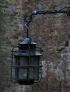 Weathered Old iron wrought Lantern on a Stone Wall of ancient Burg Castle
