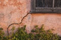 Old stucco house cabin with cracked wall crack Royalty Free Stock Photo