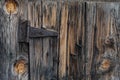 Old barn wood plank door and rusty hinge Royalty Free Stock Photo