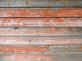 Weathered old wood texture with red flaked paint. Royalty Free Stock Photo