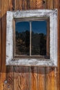 Weathered old wooden barn window in bright light Royalty Free Stock Photo