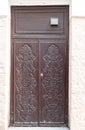 Weathered old wooden door with carved ornaments Royalty Free Stock Photo