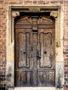 Weathered, old wooden door. Old rough and scratched wooden door in basilica, front view Royalty Free Stock Photo