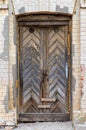 Weathered, old wooden door. Old rough and scratched wooden door. Front view Royalty Free Stock Photo