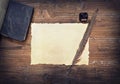 Weathered paper, ink and feather on wooden table