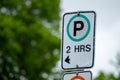 Weathered parking sign with 2-hour limit