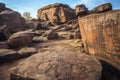 weathered petroglyphs on boulder surface