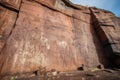 weathered petroglyphs on a cliff face