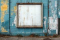 A weathered picture frame hangs prominently on a blue wall Royalty Free Stock Photo