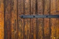 Weathered Plank Wood Gate Door with Wrought-Iron Hinge Latch. Dark Brown Earhy Color. Grungy Aged Texture Antique Look. Seamless Royalty Free Stock Photo