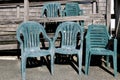 Weathered plastic chairs near a fishing shack Royalty Free Stock Photo