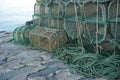 Weathered prawn traps piled on a dock in western Scotland