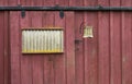 Weathered Red Barn Door with Light Fixture Royalty Free Stock Photo