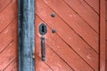 Weathered red wood door with old iron lock and handle Royalty Free Stock Photo