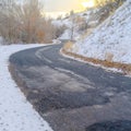Weathered road on snowy mountain at sunset