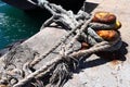 Weathered ropes attached to an anchor point in the Hout Bay harbour Royalty Free Stock Photo