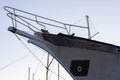 Aged sailboat bow and rigging against a pale sky Royalty Free Stock Photo