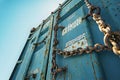 Weathered Shipping Container Secured by Chains Against a Clear B Royalty Free Stock Photo