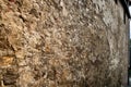 Weathered side wall of an old castle ruin, wall with heavy efflorescence and flaking