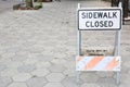 Weathered Sidewalk Closed Sign with Concrete Pavers Royalty Free Stock Photo