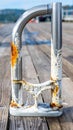 Weathered Silver Metal Dock Support with Rust and Wood Texture on a Sunny Day Royalty Free Stock Photo