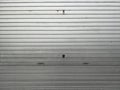 Weathered Silver Metal Roll up Shutter with Horizontal Panels and Grime Royalty Free Stock Photo
