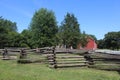 Split Rail Fence in front of an Old Barn and Farmhouse Royalty Free Stock Photo