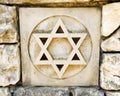 Weathered star of david in rock wall Royalty Free Stock Photo