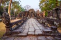 Weathered stone road and ancient temple ruins in Angkor Wat