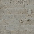 Weathered stone wall composed of rectangular limestone blocks. The surface Royalty Free Stock Photo