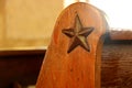 Weathered Texas star on church pew, San Antonio. Royalty Free Stock Photo