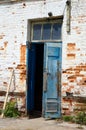 Weathered Timeworn Wooden Door Entrance to Old Brick Building