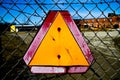 Weathered Warning Sign on Chain-link Fence in Industrial Setting Royalty Free Stock Photo