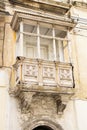 Weathered white typical maltese ornate closed wooden balcony, close up
