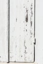 Weathered white wooden door with paint chipped and peeling. Royalty Free Stock Photo