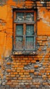 A weathered window frame clings to a textured orange wall, peeling paint and the play of shadows speaking to the passage Royalty Free Stock Photo