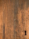 Weathered wood door with carved keyhole. Royalty Free Stock Photo