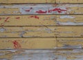 Weathered Wood Exterior with Peeling Yellow and Red Paint Royalty Free Stock Photo