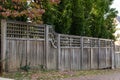 Weathered wood fence with gridded top in a fall landscape