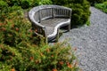 Weathered wooden bench beside a gravel path in a sunny garden Royalty Free Stock Photo