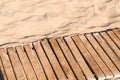 Weathered wooden boardwalk on sand Royalty Free Stock Photo