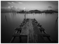 Weathered wooden bridge , lake on a lonely day Royalty Free Stock Photo