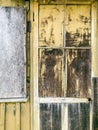 Weathered wooden door in legacy building with peeling old paint Royalty Free Stock Photo