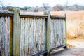 Weathered wooden fence in a field of golden prairie grass