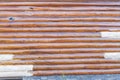 Weathered wooden logs with replaced new siding panels natural pattern grunge background in Anchorage, Alaska