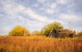 Weathered wooden sheds in colorful autumn landscape