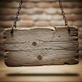 a weathered wooden sign hanging from two rusty chains against a blurred brick wall background with a light source shining on it Royalty Free Stock Photo