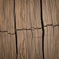 Weathered wooden surface with deep irregular cracks and a rough texture Royalty Free Stock Photo